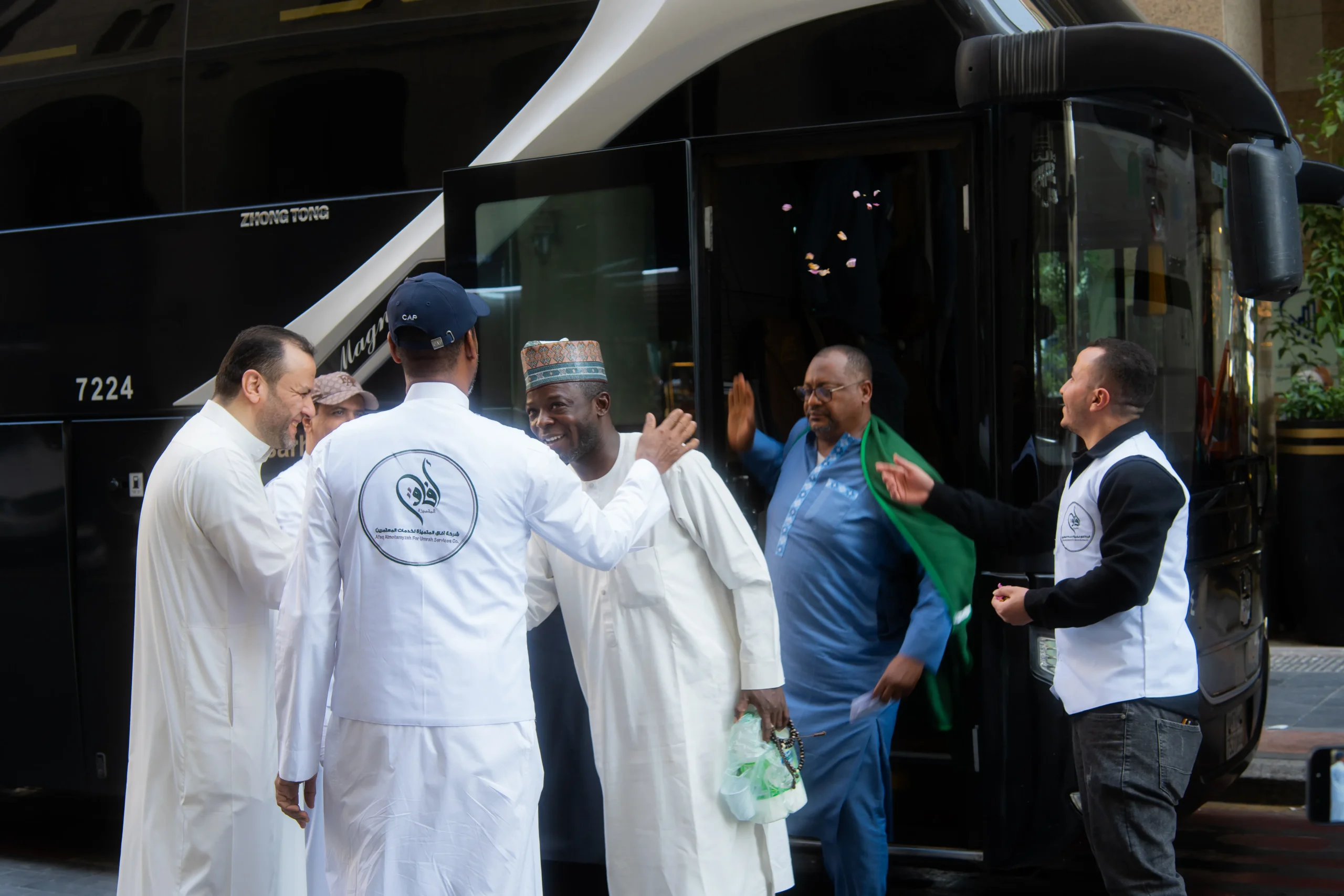 Muslim pilgrims perform Tawaf around the Kaaba in Mecca under bright lights at night.